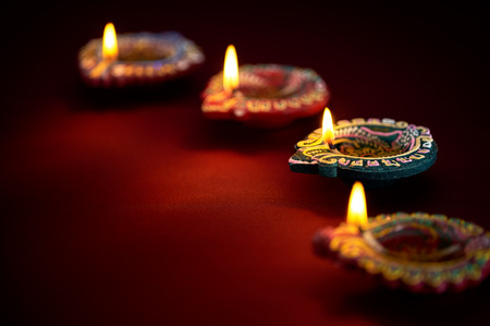 Colorful clay diya lamps lit during diwali celebration