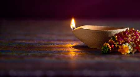 Traditional clay diya lamps lit during diwali celebrationの写真素材
