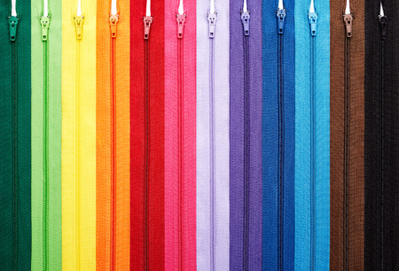 Colorful zipper collection in vertical arrangement isolatedの写真素材