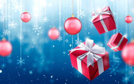 Christmas gifts and fallen defocused snowflakes on blue backgroundの写真素材