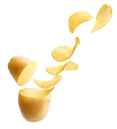 Cut potato turning into potato chips isolated on whiteの写真素材