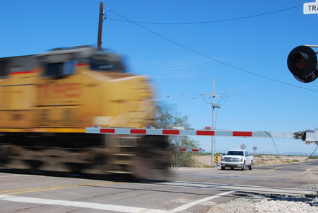 Picacho, AZ, USA - October 18, 2014: A speed blur of a locomotive passing through a railroad crossing. Taken October 18, 2014のeditorial素材