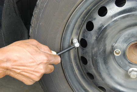 Man checking tire air pressureの写真素材