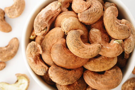 Cashew nuts burned in white bowlの写真素材