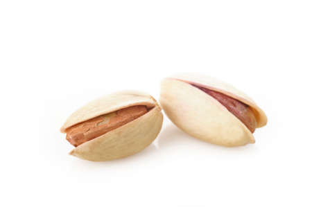 salted pistachio nuts on white backgroundの写真素材
