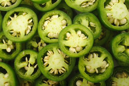 sliced green jalapeno peppers backgroundの写真素材