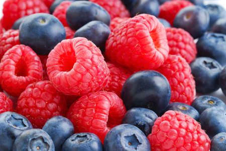 raspberries and blueberries on white backgroundの写真素材