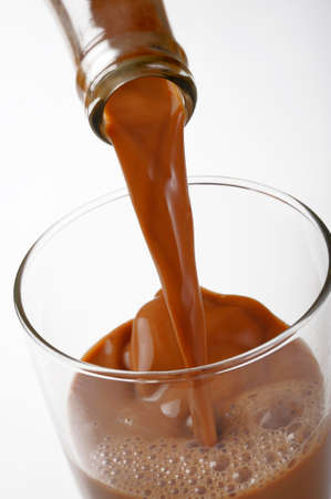 closeup pouring chocolate milkの写真素材