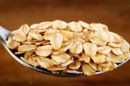 close up of oat flakes in spoon