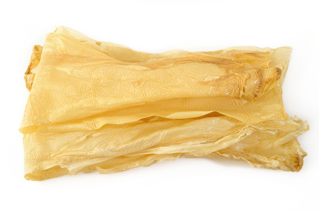 Dried tofu skin on white backgroundの写真素材