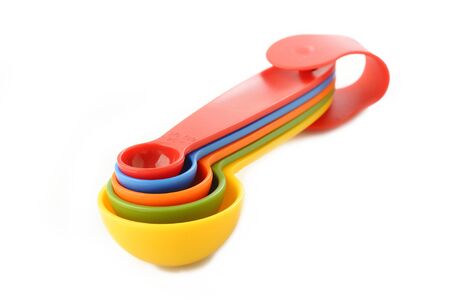 colorful plastic measuring spoon on white backgroundの写真素材