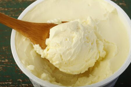 cream cheese in white plastic containerの写真素材