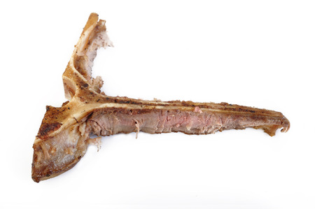 leftovers meat bone on white backgroundの写真素材