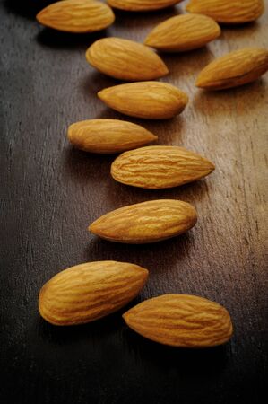raw almonds on wooden backgroundの写真素材