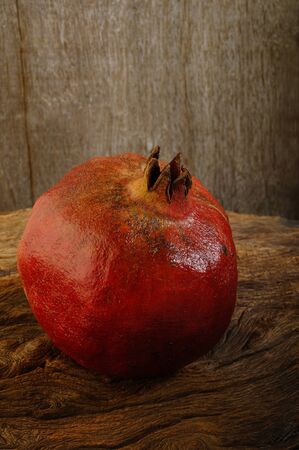 ripe pomegranate on wooden backgroundの写真素材