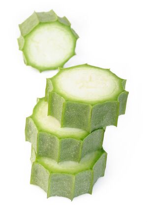 sliced angled loofah on white backgroundの写真素材