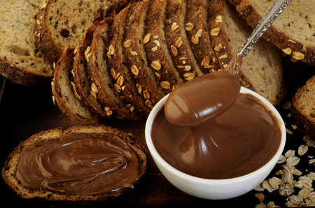 chocolate hazelnut spread in spoonの写真素材