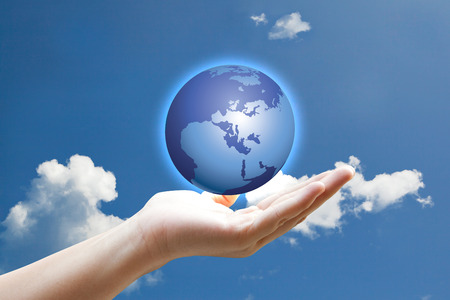 Hand and vivid light earth on sky の写真素材