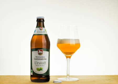 A bottle and a tasting glass of Neumarkter Lammsbraeu Urstoff Hellesのeditorial素材