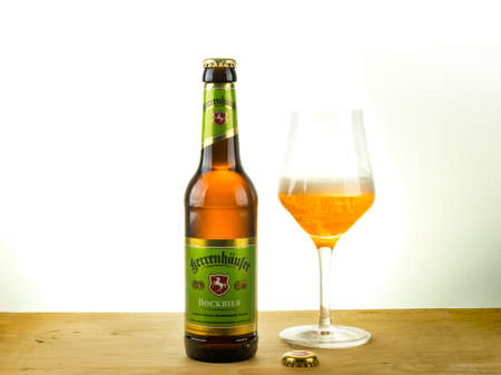 A bottle and a tasting glass of Herrenhaeuser Bock beerのeditorial素材