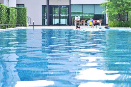 Swimming pool with swimmer, background blurredの写真素材