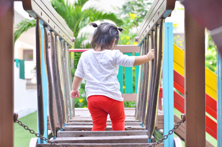 Asian little girl playing on playground bangkok thailandの写真素材