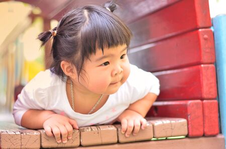 Asian little girl playing on playground bangkok thailandの写真素材