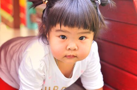 Asian little girl playing on playground bangkok thailandの写真素材