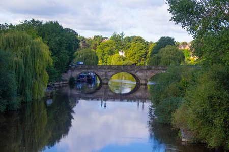Bridge reflecting on the river Severn in Shrewsbury Shropshire