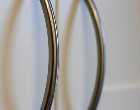 Silver curved cupboard door handle close up bokeh.の写真素材