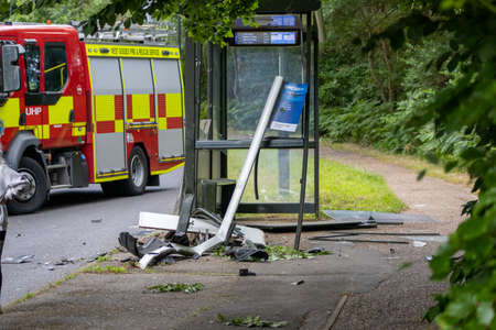 CRAWLEY WEST SUSSEX UK - JUL 02 2022: RTA Damaged bus stop with fire engine in backgroundのeditorial素材