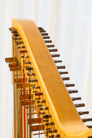 Close up of the string adjustment of a Celtic harp.