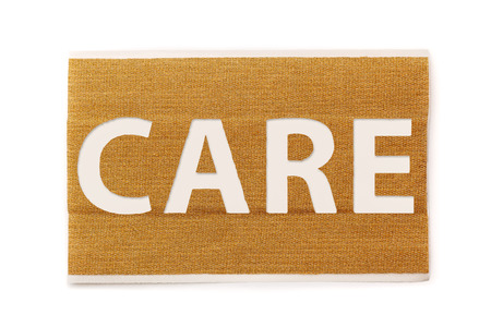 Strip of band aid with text care cut out, isolated on a white background. Healthcare, hospital, cure, care, relief.の写真素材