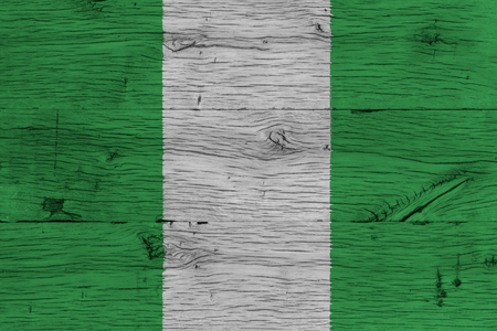 Nigeria national flag painted on old oak wood. Painting is colorful on wood of old train carriage.の写真素材
