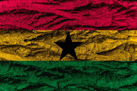 Ghana, Ghanese national flag painted on wooden bark of tree. Painting is rough and colorful.の写真素材