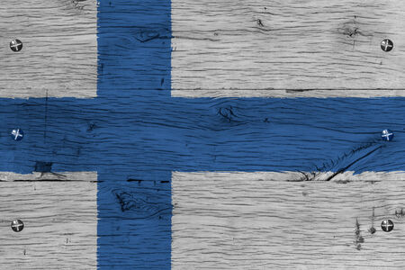Finland,  Finnish national flag. Painting is colorful on wood of old train carriage. Fastened by screws or bolts.の写真素材