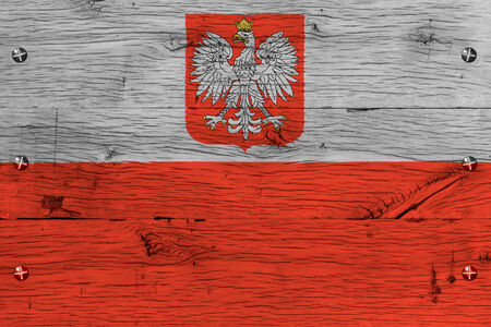 Poland, Polish national flag. Painting is colorful on wood of old train carriage. Fastened by screws or bolts.の写真素材