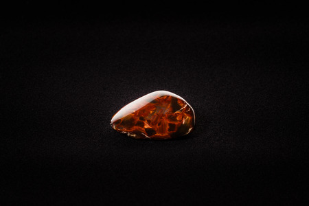 Piece of pietersite originating from Namibia Africa on velour fabric. Metamorphic gem stone type of tiger eye.の写真素材