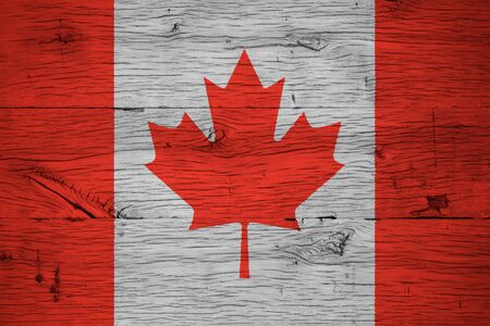 Canada, Canadian national flag painted on old oak wood. Painting is colorful on planks of old train carriage.の写真素材