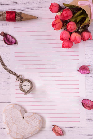 Top view flat lay shot of letter paper envelope and flower petals pocket watchの写真素材