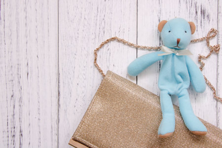 Stock photography retro white vintage painted wood floor background blue bear luxury golden purseの写真素材