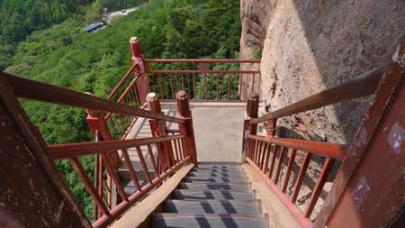 Maijishan Cave-Temple Complex ladder in Tianshui city, Gansu Province China. A mountain with...