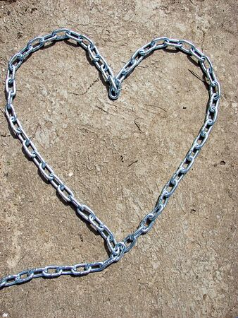 Heart shape from chain on concrete roadの写真素材