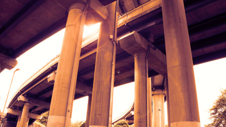 Curved highway elevated on concrete pillars from a low angle の写真素材