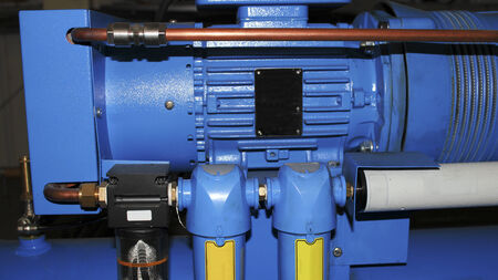 Blue industrial compressor components close up.
