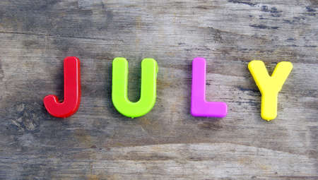 colored plastic letters on gray boards julyの写真素材
