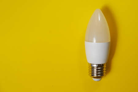 White led light bulb on yellow backgroundの写真素材
