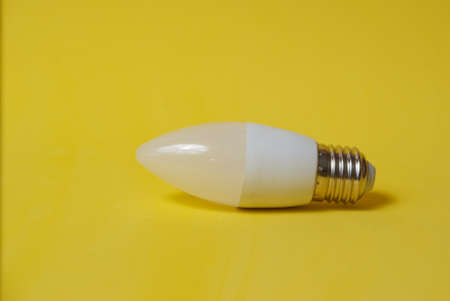 White led light bulb on yellow backgroundの写真素材