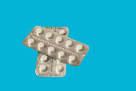 Medical pills on green background top view