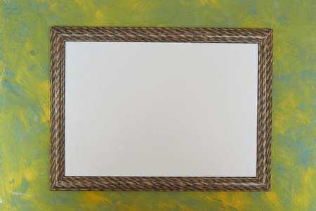 wooden photo frame with white photo on abstract backgroundの写真素材
